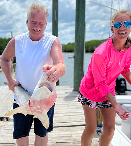 Melissa Leone with Angler holding a shark